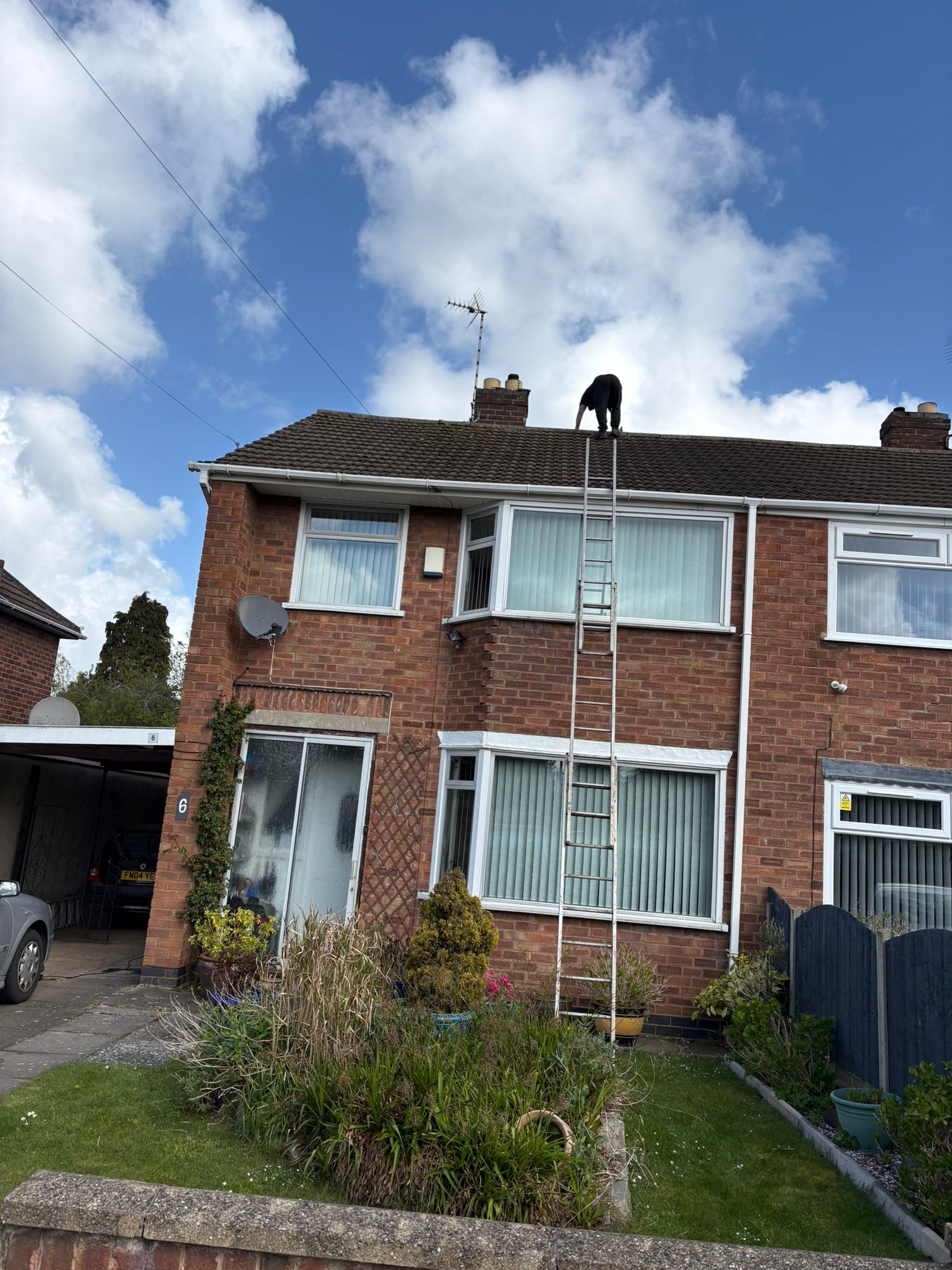 Roofer Accessing Roof via Ladder