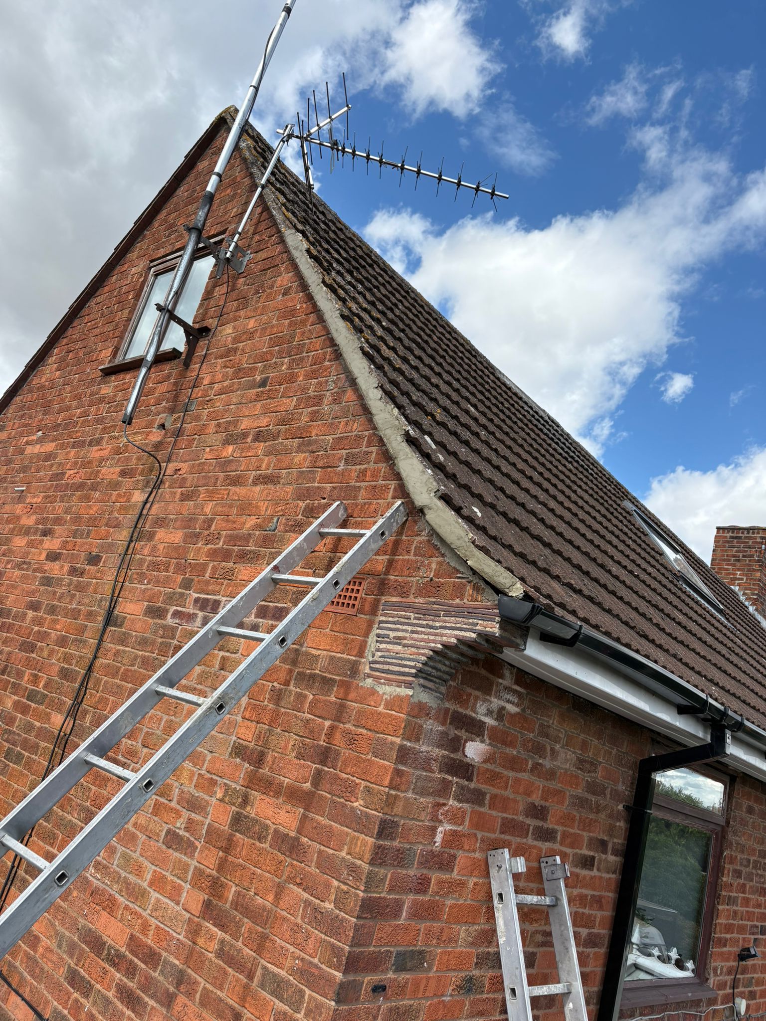 New verge and fascia mortar work along a tiled roof edge